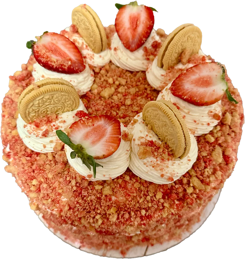top view of a round cake covered in pink strawberry crunch crumbs